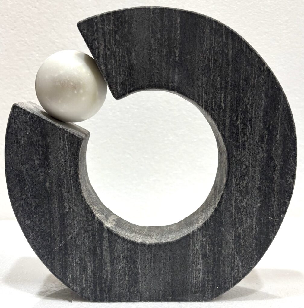 Black Marble Object with White Marble Ball